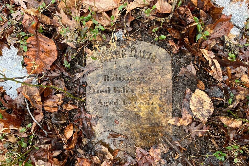 A grave marked "Mark Davis" is pictured on the grounds of the House of Reformation for Colored Children, a closed down segregated juvenile detention facility, in Cheltenham, Maryland, on February 17, 2026.