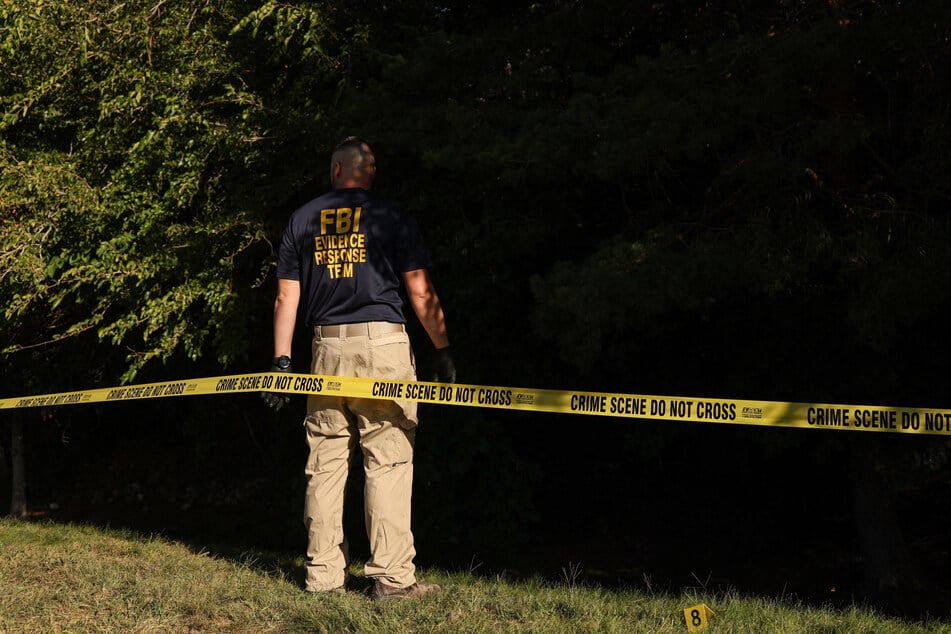 The FBI released pictures of a person of interest on Thursday after detaining – then releasing – two individuals in connection with the shooting.