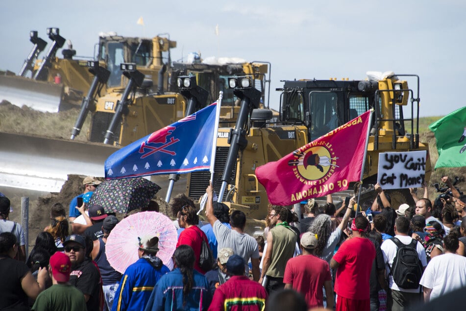 Members of the Standing Rock Sioux Tribe and their supporters opposed to the Dakota Access Pipeline (DAPL) confront bulldozers working on the new oil pipeline in an effort to make them stop on September 3, 2016, near Cannon Ball, North Dakota.