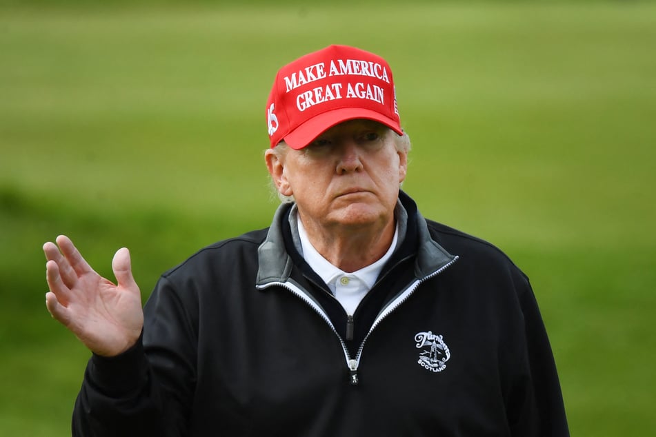 Donald Trump waves as he plays golf at the Trump Turnberry Golf Courses on the west coast of Scotland on May 2, 2023.