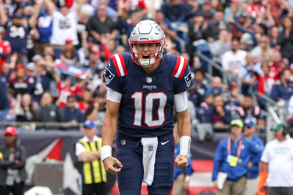 New England Patriots quarterback Mac Jones celebrates after a touchdown during the second half against the Baltimore Ravens at Gillette Stadium.