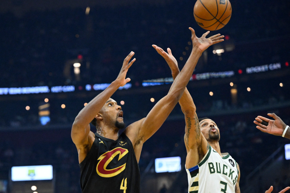 Cleveland Cavaliers forward Evan Mobley (l.) rebounds against Milwaukee Bucks guard George Hill at Rocket Mortgage FieldHouse on Saturday.