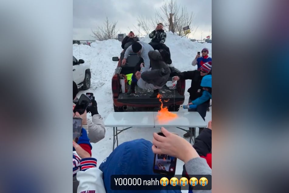 One fan caught fire after he dove onto a table lit with lighter fluid at a tailgate in Buffalo.