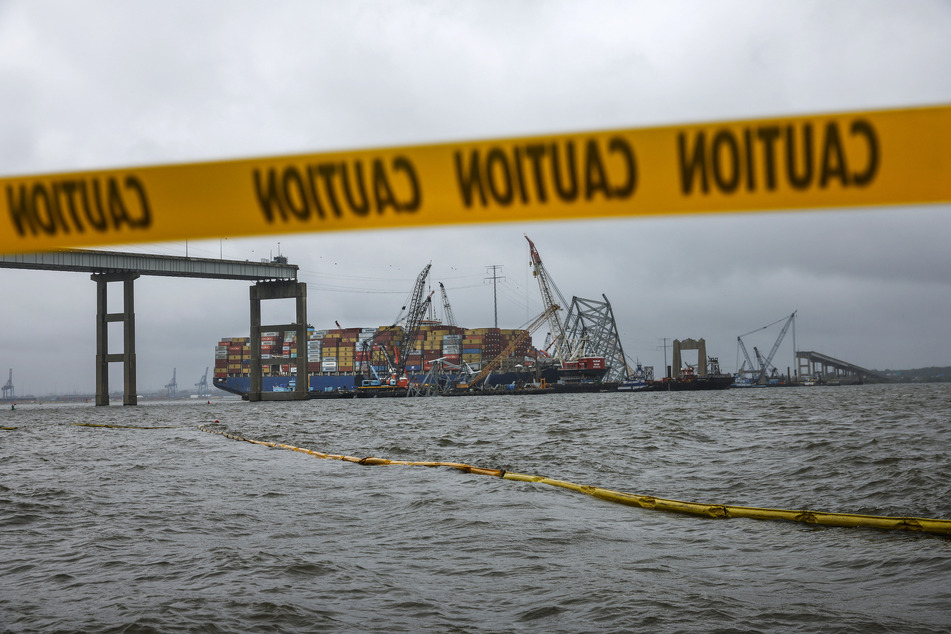 Salvage crew members continue to work to free the cargo ship Dali after if collided with the Francis Scott Key Bridge in the Patapsco River on May 10, 2024 in Baltimore, Maryland.