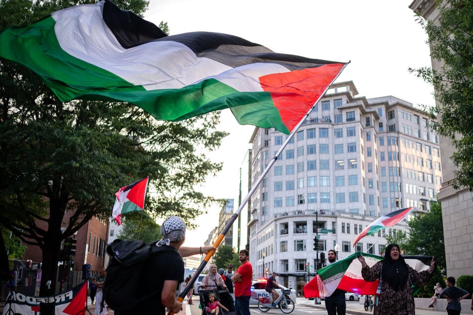 Protesters in support of Palestine gather outside security fencing near the White House in Washington DC on July 7, 2025.
