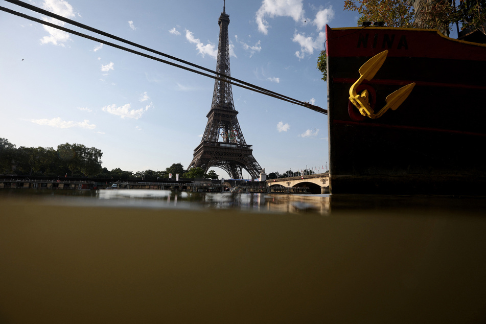 The Eiffel Tower is visible from the Triathlon start in the River Seine after the men's race was postponed amid water quality concerns.