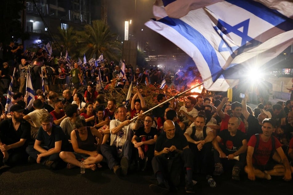 Protesters block Tel Aviv's Ayalon highway during an anti-government rally calling for the release of Israelis held hostage in Gaza.