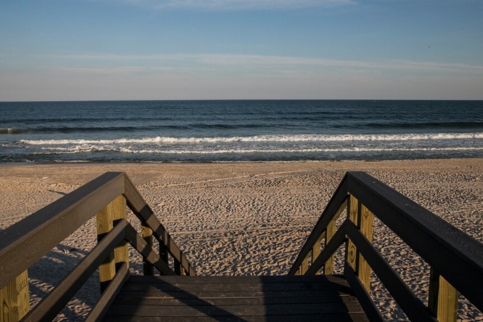 Smith Point Beach in Shirley, NY was forced to close on Sunday, along with nearby Cupsogue, after a lifeguard survived a shark attack.