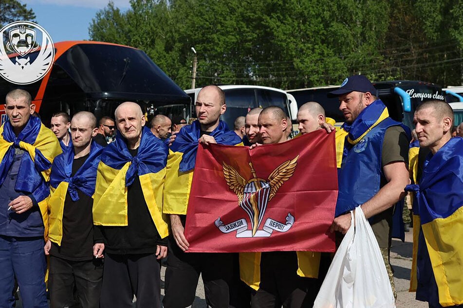 This handout photograph taken and released by Coordinating Headquarters for the Treatment of Prisoners of War on Friday shows Ukrainian POWs posing after their exchange, amid the Russian invasion in Ukraine.