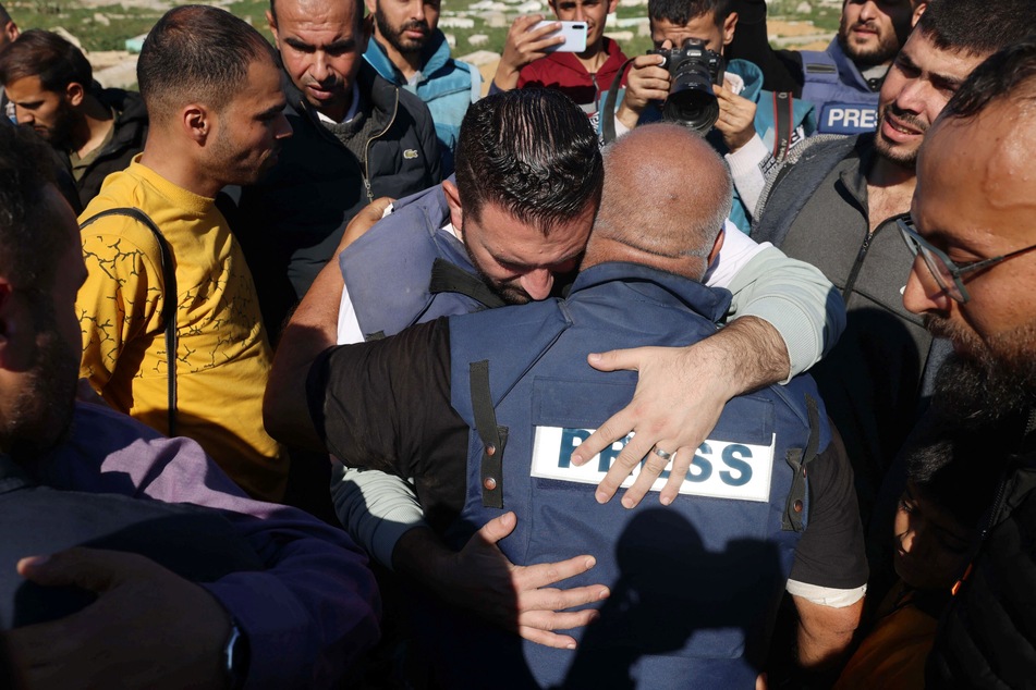 Al Jazeera's bureau chief in Gaza, Wael Al-Dahdouh (c.) is comforted during the funeral of his son Hamza Wael Dahdouh, a journalist with the Al Jazeera television network, who was killed in a reported Israeli air strike, in Rafah in the Gaza Strip on January 7, 2024.