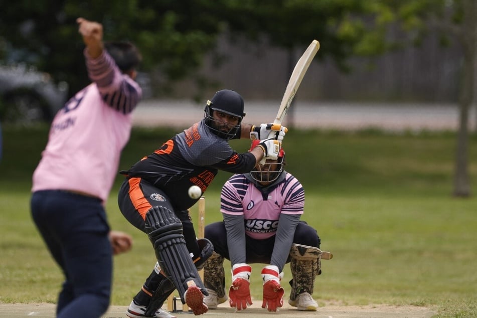 A batter from Long Island United Cricket Club hits the ball as they play during the Commonwealth Cricket League at Eisenhower Park in New York.
