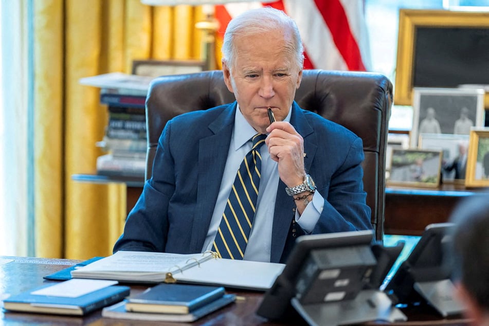 President Joe Biden speaks on the phone with Israeli Prime Minister Benjamin Netanyahu in this White House handout image taken in the Oval Office in Washington DC.