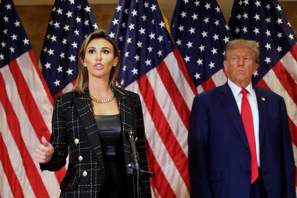 Donald Trump (r.) stands with his lawyer Alina Habba (l.) speaking with the media following closing arguments for their New York fraud trial on January 11, 2024.