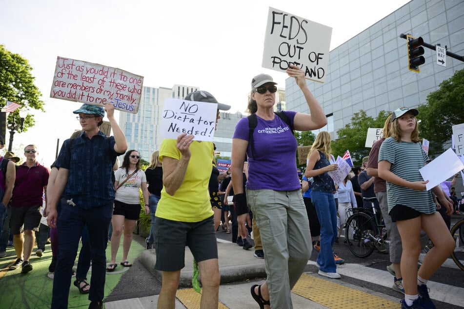 Protesters turned out to oppose President Donald Trump's deployment of National Guard troops as Oregon launched a lawsuit against the administration.