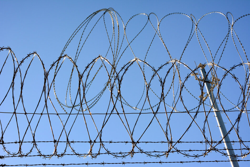 Barbed wire on US-Mexican border fence. Every month thousands of people try to get from Mexico to the USA.