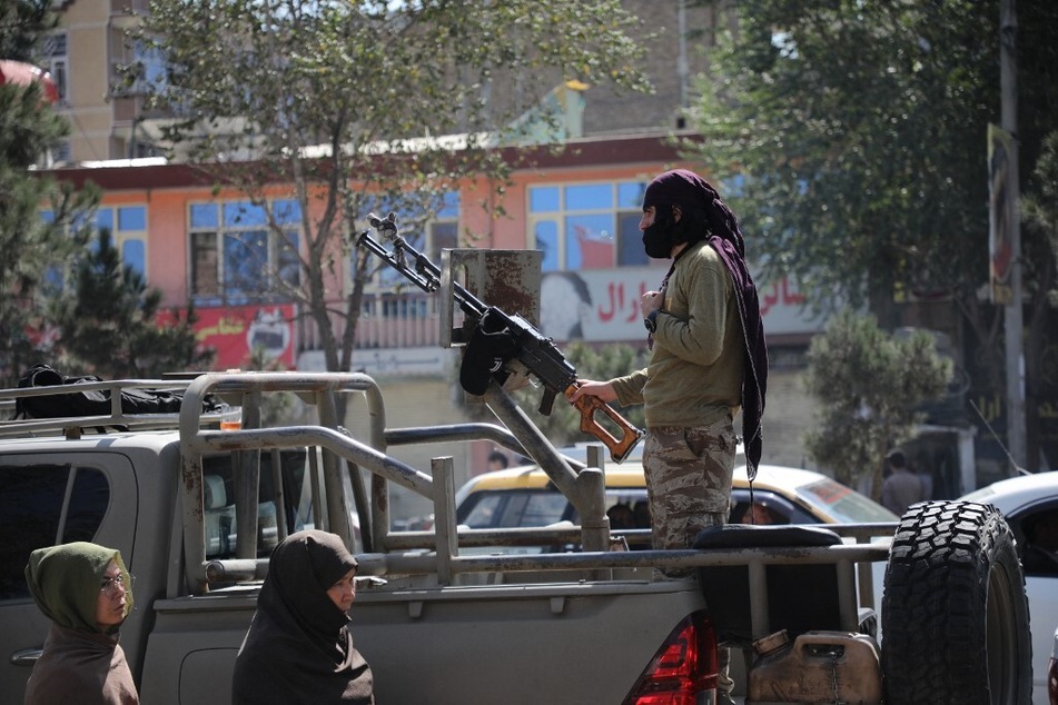 A Taliban fighter stands guard in the Dasht-e-Barchi area in Kabul, Afghanistan.