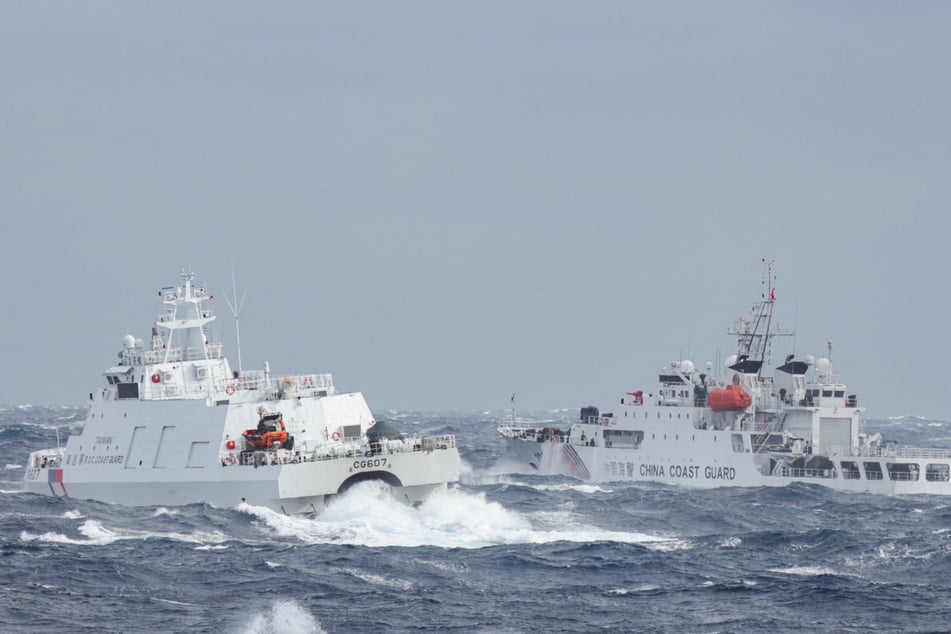 This handout photo taken and released by Taiwan's Coast Guard on December 12, 2024, shows a Taiwanese coast guard ship (L) monitoring a Chinese coast guard ship, a few nautical miles from Taiwan's northeastern coast.