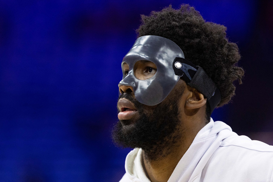 Sixers center Joel Embiid wears a protective mask during warm-ups before game three of the second round of the 2022 NBA playoffs against the Miami Heat.