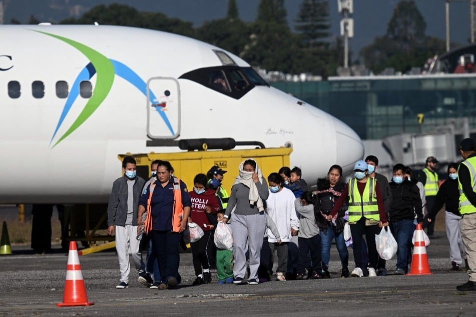 Guatemalan migrants deported from the United States walk down the runway after arriving at the Guatemalan Air Force Base in Guatemala City on December 27, 2024.