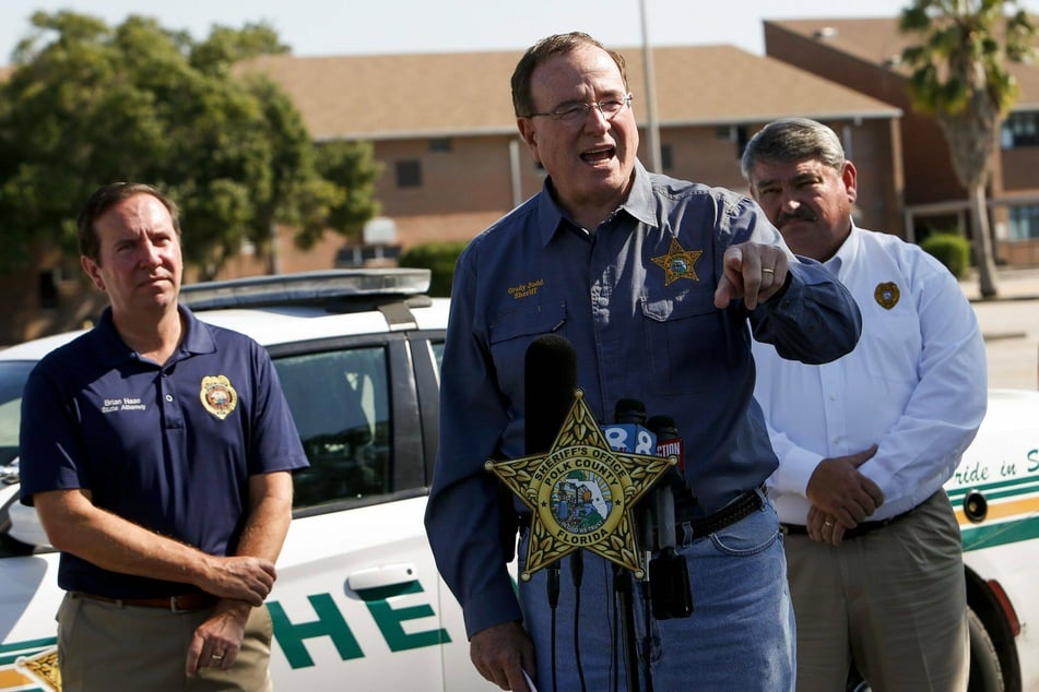 Polk County Sheriff Grady Judd (c) speaking during a press conference on Sunday.