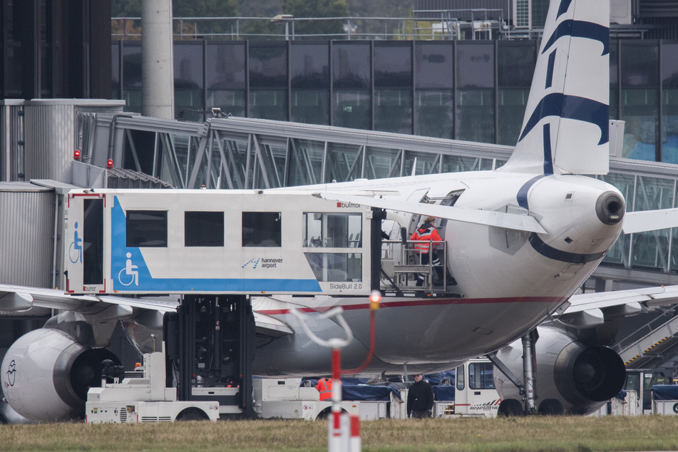 Medizinisches Personal steigt am Flughafen Hannover aus einem Flugzeug der griechischen Fluggesellschaft Aegean Airlines, das Migranten aus griechischen Flüchtlingslagern nach Deutschland gebracht hat.