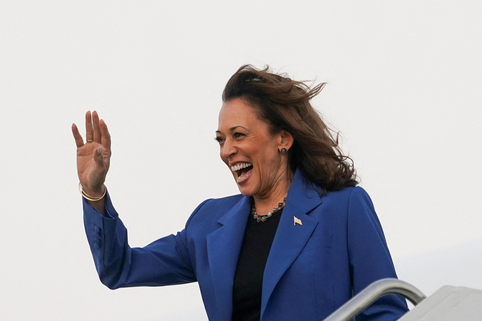 Vice President Kamala Harris waves upon arrival in Chicago, Illinois, ahead of the Democratic National Convention.