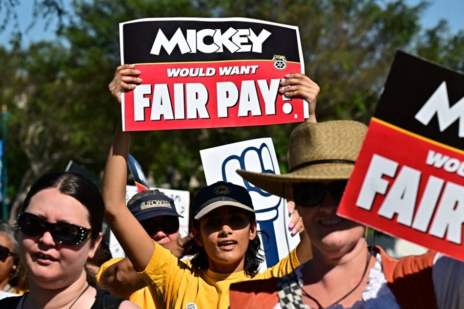 Cast members rally outside the main entrance of Disneyland Resort in Anaheim, California.