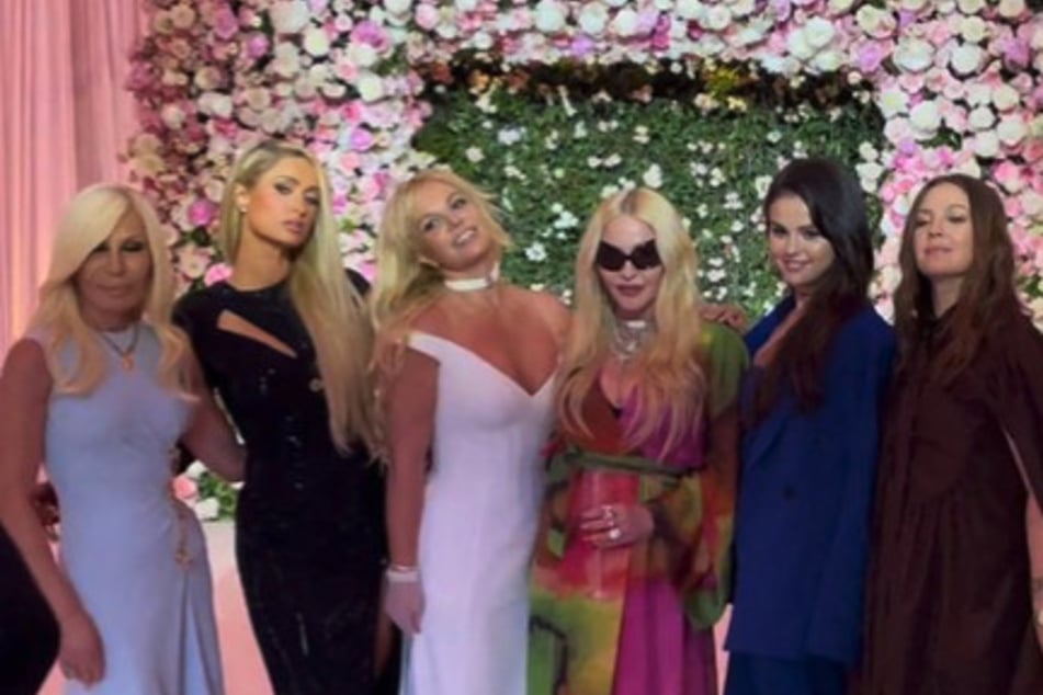 (From l to r:) Donatella Versace, Paris Hilton Madonna, Selena Gomez, and Drew Barrymore pose with blushing bride Britney Spears (c.) on her wedding day.