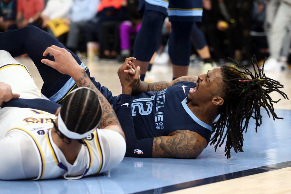 Memphis Grizzlies guard Ja Morant reacts after falling to the ground during the second half of Game 1 of the 2023 NBA playoffs against the Los Angeles Lakers at FedExForum.