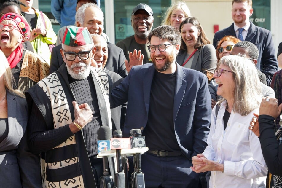 (From l. to r.) African People's Socialist Party Chairman Omali Yeshitela, Uhuru Solidarity Movement Chair Jesse Nevel, and African People's Solidarity Committee Chair Penny Hess rally with supporters outside the Sam Gibbons US District Courthouse in Tampa, Florida, on December 16, 2024.