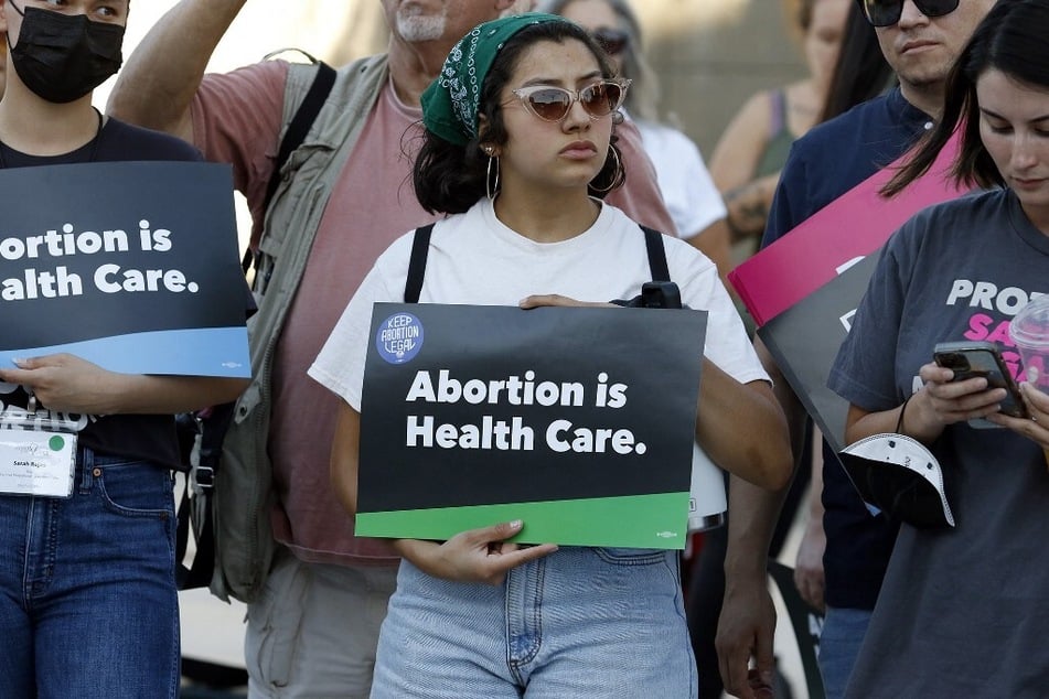 A woman holds an "Abortion is Health Care" sign during a rally outside the Lloyd D. George Federal Courthouse in Las Vegas, Nevada, following the June 2022 overturning of Roe Vs. Wade by the US Supreme Court.