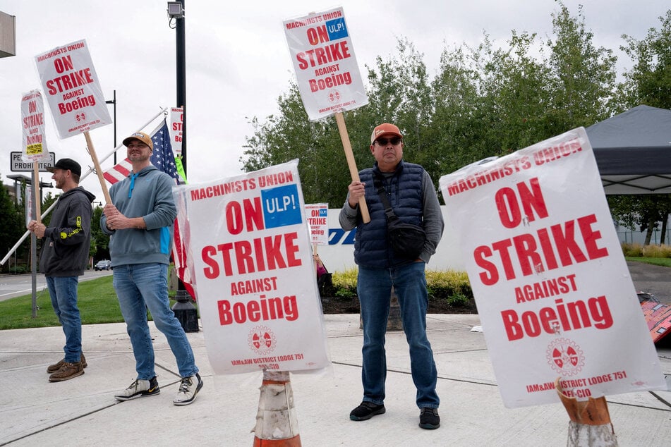 Boeing factory workers and supporters gather on a picket line near the entrance to a production facility in Renton, Washington.