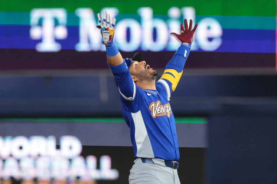 Venezuela third baseman Eugenio Suarez reacts after hitting an RBI double against the USA in the ninth inning during the 2026 World Baseball Classic Championship game.