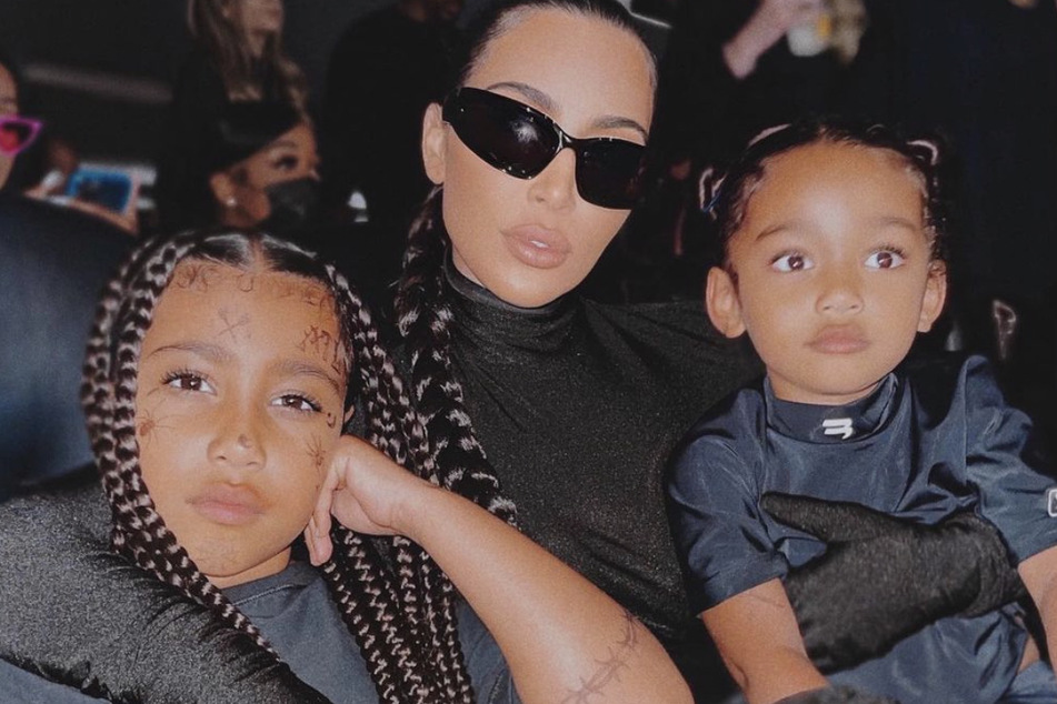 Kim Kardashian (c.) attends Kanye "Ye" West's listening party for Donda with North (l.) and Chicago West.