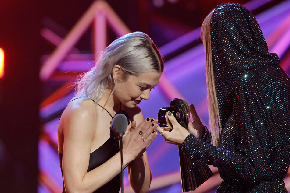 Phoebe Bridgers (l) gave a heartfelt speech about Taylor Swift while presenting at the iHeartRadio Music Awards last month.