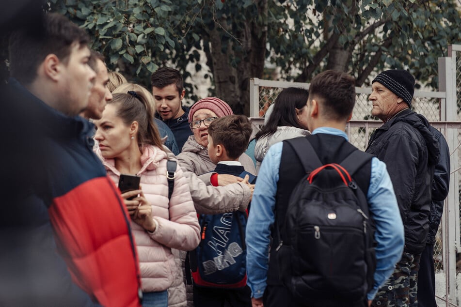 A woman hugs a boy near the scene of a shooting in school No88 in Izhevsk on Monday.