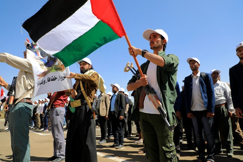 Yemen's Houthi recruits wave a Palestinian flag during a rally against the US, the UK, and Israel.