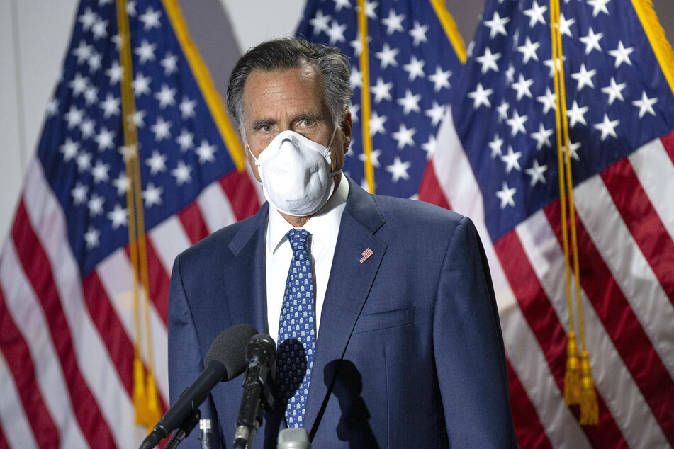 Senator Mitt Romney wearing a mask while speaking to reporters in Washington.