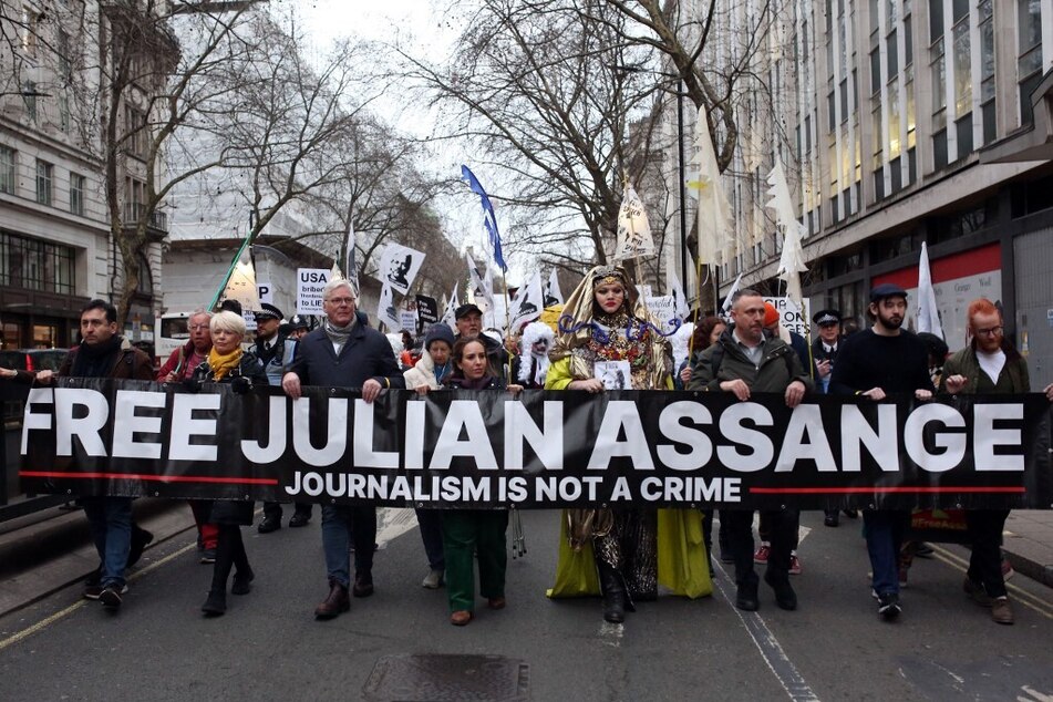 Supporters of Julian Assange march in London for the WikiLeaks founder's release.