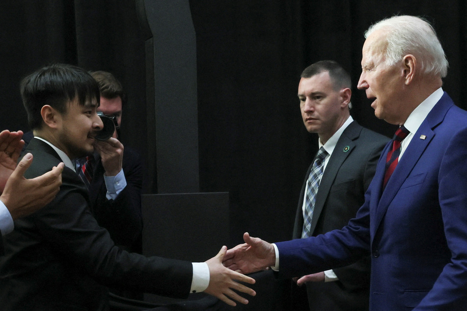 Biden shakes hands with Brandon Tsay, the man who disarmed the Monterey Park mass shooter.