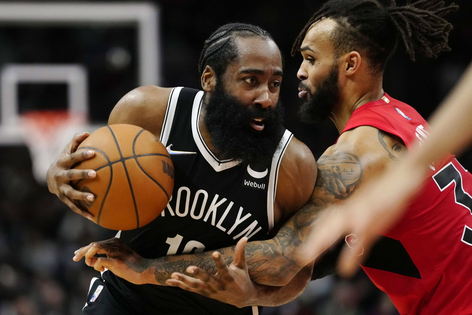 Nets guard James Harden (l) just missed a triple-double by two assists on Sunday.