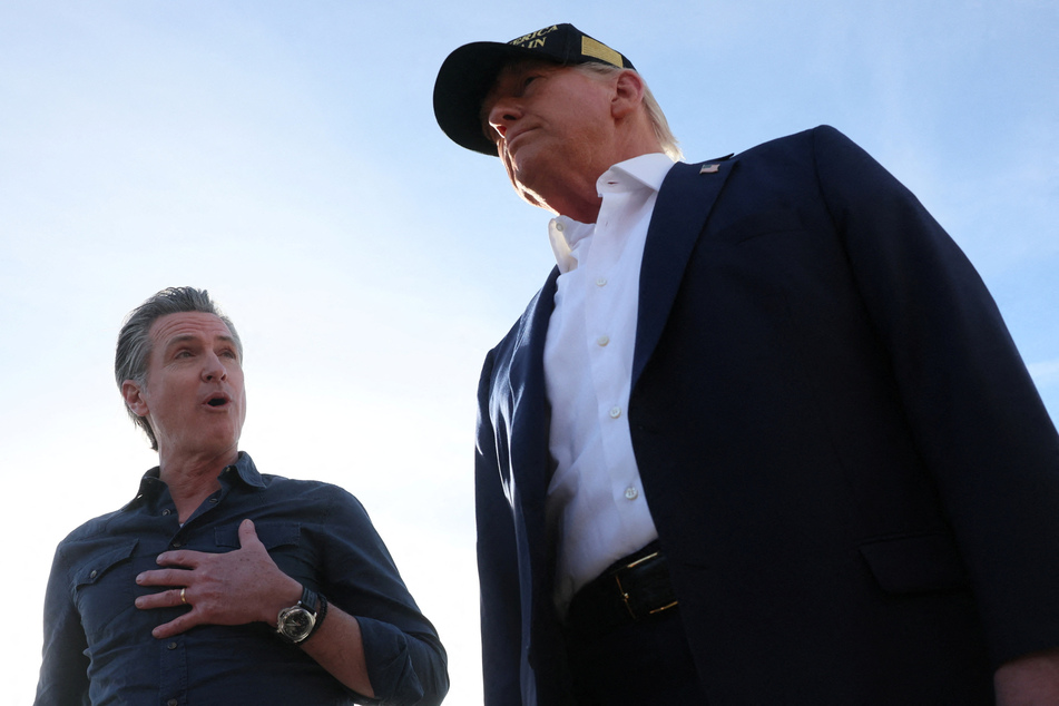 California Governor Gavin Newsom (l.) speaks to President Donald Trump upon the latter's arrival to tour areas impacted by the southern California wildfires on January 24, 2025.