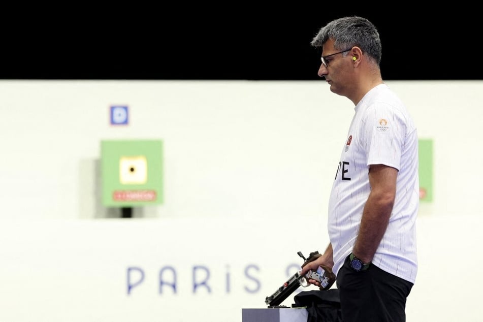 Turkey's Yusuf Dikec competes in the shooting 10m air pistol mixed team gold medal match during the Paris Olympic Games.