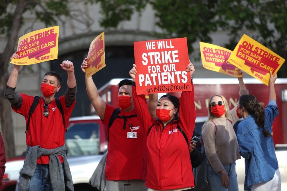 Over 8,000 registered nurses and health care workers participate in a one-day strike at 15 facilities across Northern California to protest Sutter Health's refusal to acknowledge proposals regarding safe staffing and health and safety protections.