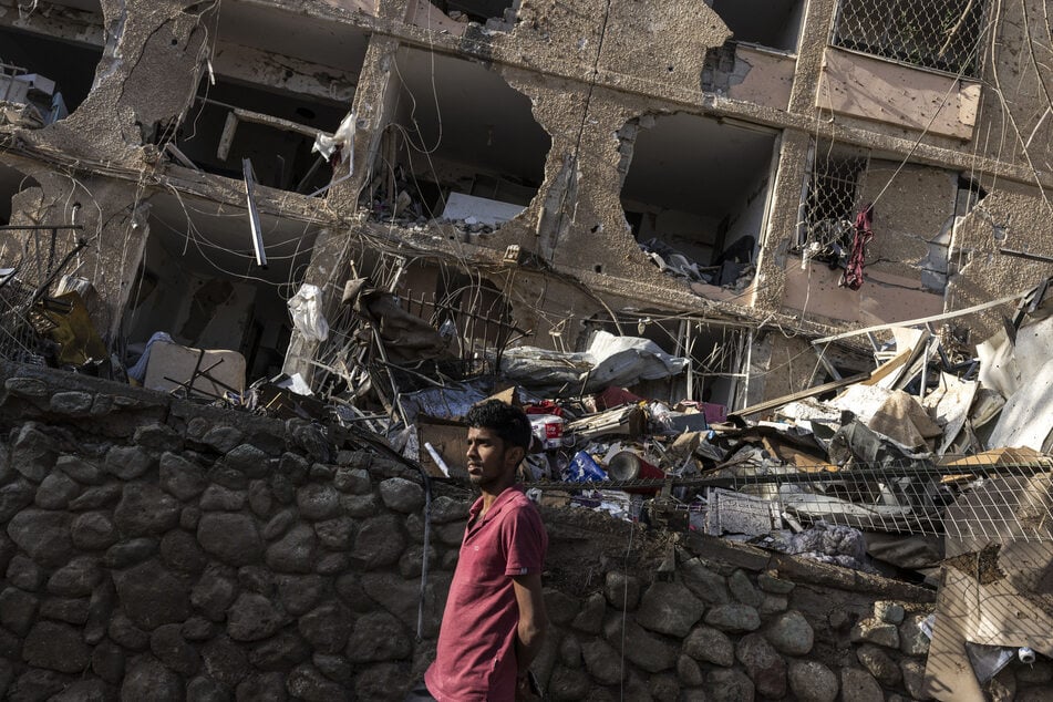 A man walks through the site of an Iranian missile strike in Dimona on March 22, 2026.