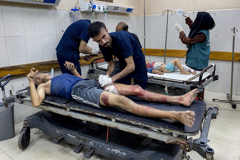 A Palestinian man and boy receive treatment for injuries sustained during Israeli bombardment at Nasser Medical Complex in Khan Younis in the southern Gaza Strip.