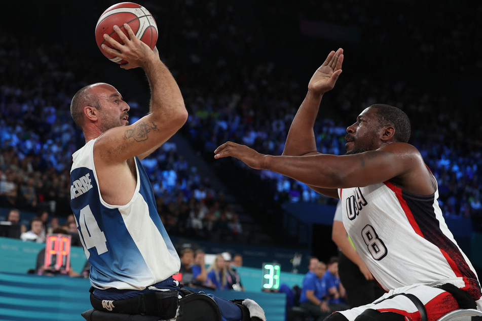 Team USA's Brian Bell defends Nicolas Jouanserre of France during the wheelchair basketball men's quarter-final at the Paris Paralympics.