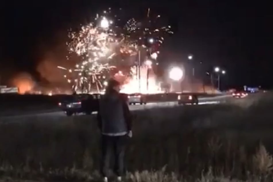 A passer-by watches the catastrophe unfolding before his eyes in disbelief.