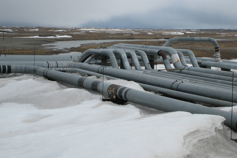 An oil and petroleum extraction site in Alaska including drilling wells and pipelines for transportation of crude oil.
