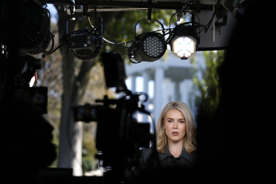 Press Secretary Karoline Leavitt participates in a television interview outside of the White House in Washington DC.